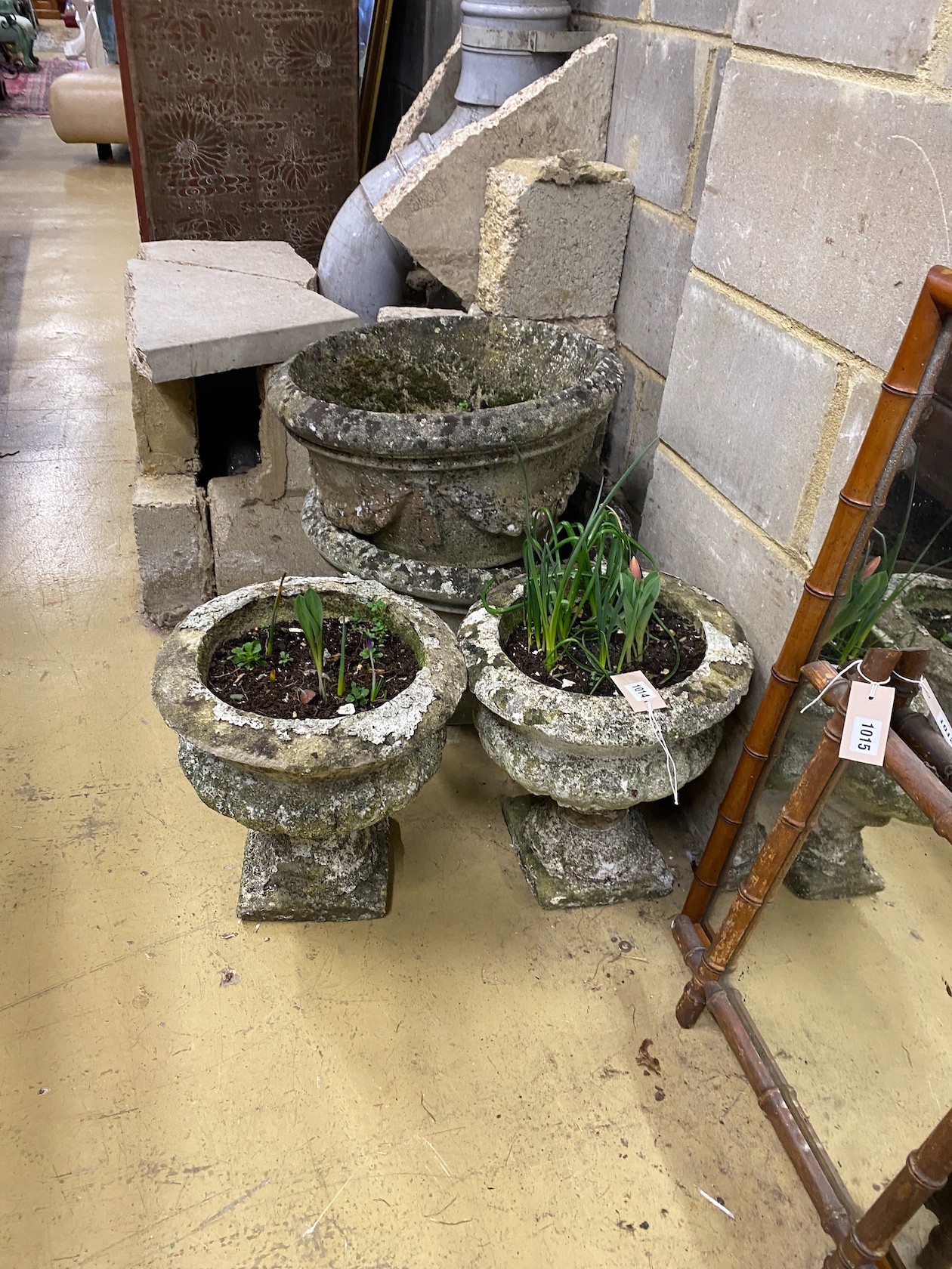 Four circular reconstituted stone garden planters, largest diameter 48cm, height 32cm